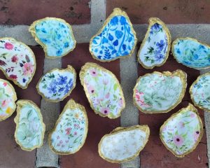 painted oyster shells set on a brick background
