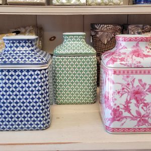 three decorative containers in different colors