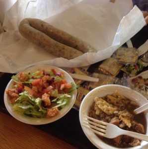 boudin in wrapper, salad, and gumbo with crackers