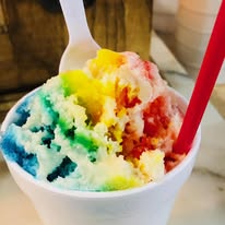 close-up of multi-colored snowball with spoon and red straw