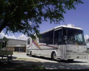 RV in the background with tree in the foreground