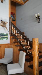 stairway featuring deer antlers as the railing