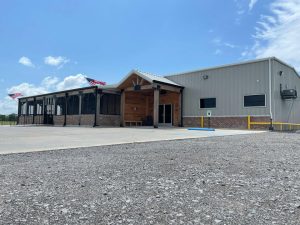 metal building exterior with wooden porch and large patio