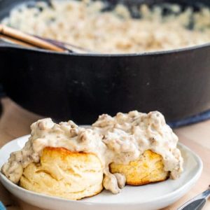 biscuits with white gravy with black pot in the background