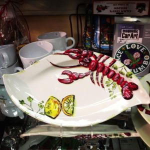 white platter with large crawfish and lemons painted on it