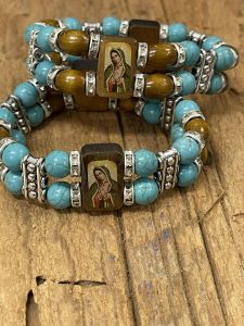 two bracelets with turquoise rosary beads and religious images