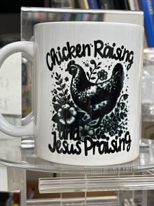 white mug with black image that reads chicken raising, Jesus praising