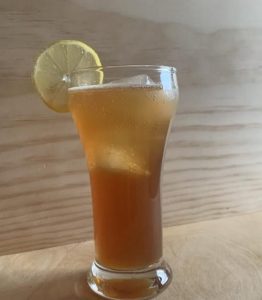 Mixed drink with lemon wedge