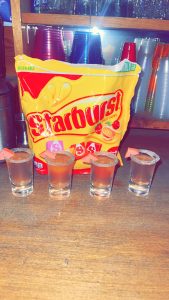 bag of starburst with shots lined up in front