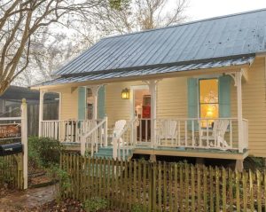 Cajun cottage with front porch and picket fence