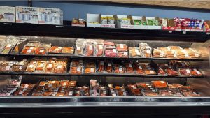 store cooler with assortment of specialty meats