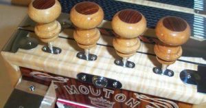 close up of accordion knobs with Mouton engraved on the side