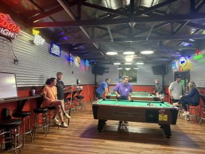 interior of bar with pool tables and bar stools