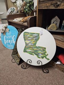 painting of Louisiana with nic naks in the background