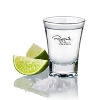 shot glass with two lime wedges