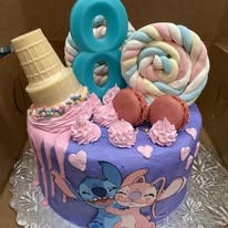 purple stitch cake with ice cream and cookies on top with an 8