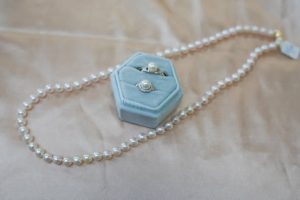 pearl jewelry in a box, with a pearl necklace around the outside