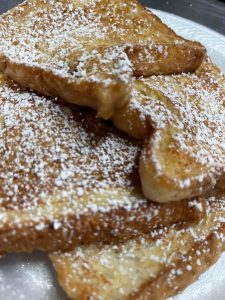 stack of French Toast with powdered sugar on top