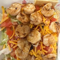 salad topped with grilled shrimp