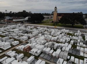 whitewashed graves in the foreground with a church in the background