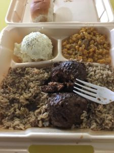 Plate lunch with meatball stew, mashed potatoes, corn, and a roll
