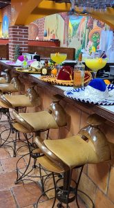 saddle barstools at bar with sombreros and margaritas