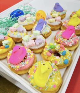iced donuts decorated with candies and peeps 