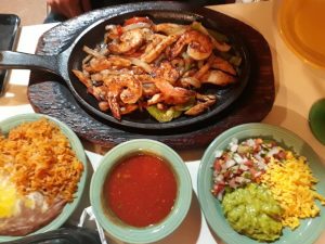 fajitas on hot pan with toppings