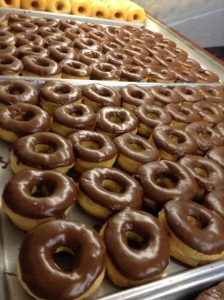 large tray of chocolate donuts