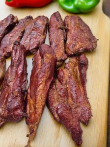 smoked pork tasso on a cutting board