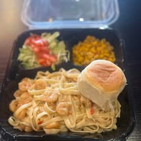 plate lunch with fettucini, roll, side salad, and corn