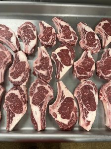 bone-in ribeyes on a metal tray