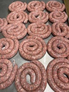 rolled up sausages on metal table