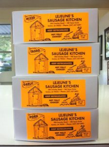 stack of four white sausage boxes with yellow "Lejeune's Sausage Kitchen" label