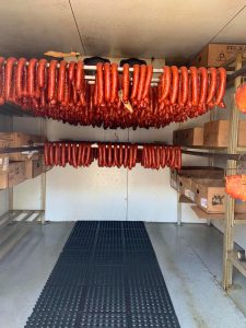 sausage links hanging in cooler