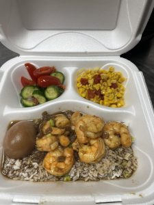 plate lunch with shrimp over rice with veggies