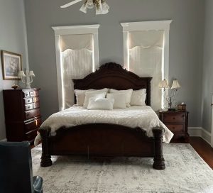 large wooden bed with white covers