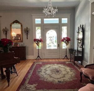 Victorian-style foyer with chandelier and area rug