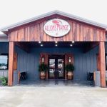 front of building with Allons Mange sign