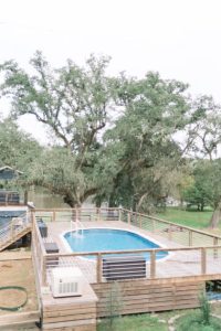 above ground pool with rectangular deck surrounding it
