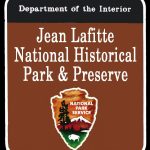 Jean Lafitte National Historical Park and Preserve with arrowhead national park service logo on a brown background