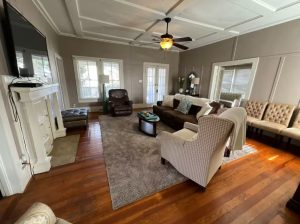 living room with hardwood floors, gray walls, neutral furniture