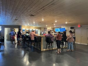 interior of l-shaped bar with patrons on barstools
