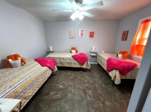 large bedroom with three beds