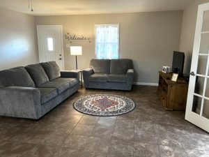 living room with tile floor and gray furniture