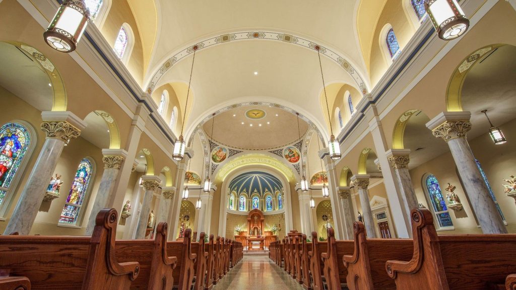 interior of ornate church with wooden pews and high ceilings