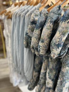 row of blue clothes on hangars