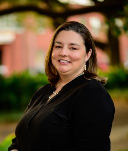 Woman in black shirt with oak trees in the background