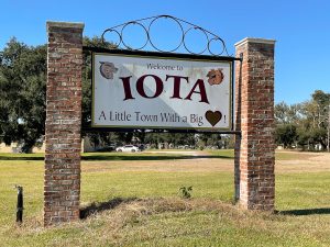 sign between brick columns, reads Iota in big letters, a little town with a big heart