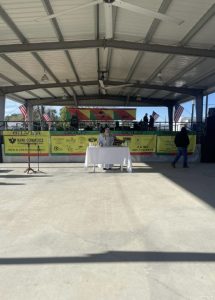 Priest at a table holding outdoor mass under pavilion